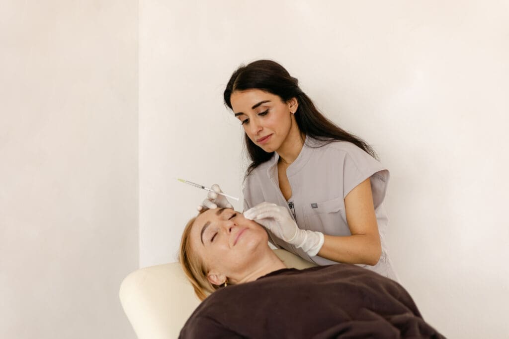 Dr Kamal Kaur administering injectable treatment for dark under eye circles at My Cosmetic Doctor, Birmingham